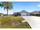 House exterior with two-car garage and well-manicured lawn at 2111 Nw 58Th Ct, Ocala, FL 34482