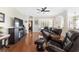 Relaxing living room with leather reclining furniture and hardwood floors at 2111 Nw 58Th Ct, Ocala, FL 34482