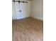 Bedroom with barn door and light wood laminate flooring at 2317 Ne 37Th St, Ocala, FL 34479