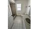 Clean bathroom with a bathtub, toilet, and sink at 2849 Sw 140 Pl, Ocala, FL 34473