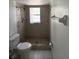 Clean bathroom with shower, toilet, and window at 2849 Sw 140 Pl, Ocala, FL 34473