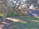 Backyard with grass, trees, and wooden fence at 2969 Sw 142Nd Ln, Ocala, FL 34473