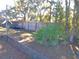 Partially fenced backyard with trees and play area at 2969 Sw 142Nd Ln, Ocala, FL 34473