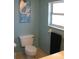 Bathroom with toilet and ocean-themed wall art at 2969 Sw 142Nd Ln, Ocala, FL 34473