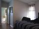 Main bedroom with dark-wood flooring and a view into the bathroom at 2969 Sw 142Nd Ln, Ocala, FL 34473