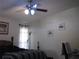 Bedroom with ceiling fan, window, and wood flooring at 2969 Sw 142Nd Ln, Ocala, FL 34473