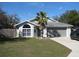 Single-story house with a two-car garage and palm tree landscaping at 2969 Sw 142Nd Ln, Ocala, FL 34473