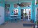 Bright Florida room with turquoise walls, pool view, and patio furniture at 2969 Sw 142Nd Ln, Ocala, FL 34473