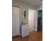 Light hallway with white closet doors and small cabinet at 2969 Sw 142Nd Ln, Ocala, FL 34473