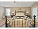 Main bedroom with a king-size bed and an ornate headboard at 3165 Hudson Ct, The Villages, FL 32162