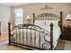 Spacious bedroom with ornate bed frame and neutral color scheme at 3165 Hudson Ct, The Villages, FL 32162