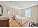 Cozy bedroom featuring a queen-size bed and wood flooring at 3165 Hudson Ct, The Villages, FL 32162