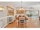 Elegant dining room featuring a rustic wooden table and white chairs at 3165 Hudson Ct, The Villages, FL 32162