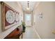 Bright entryway with tiled floor, decorative wall hangings, and a console table at 3165 Hudson Ct, The Villages, FL 32162