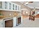 Kitchen wet bar with wine cooler and granite countertop at 3165 Hudson Ct, The Villages, FL 32162