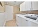 Bright laundry room with washer, dryer, and cabinets at 3165 Hudson Ct, The Villages, FL 32162