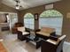 Cozy sunroom featuring tile floors, ample light, and a comfortable sitting area adjacent to the Primary bedroom at 3165 Hudson Ct, The Villages, FL 32162