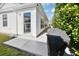 Exterior patio with grill and lush landscaping at 3165 Hudson Ct, The Villages, FL 32162