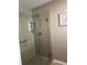 Large shower with glass enclosure, built-in seat, and grab bar at 3165 Hudson Ct, The Villages, FL 32162