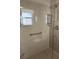 Walk-in shower with glass enclosure and built-in seat at 3165 Hudson Ct, The Villages, FL 32162