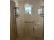 Walk-in shower with glass enclosure, built-in seat, and shelves at 3165 Hudson Ct, The Villages, FL 32162