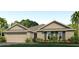 One-story home with two-car garage, landscaped yard, and attractive exterior at 336 Hickory Course Trl, Ocala, FL 34472