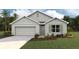 One-story home with gray siding, a two-car garage, and landscaping at 342 Hickory Course Trl, Ocala, FL 34472