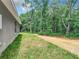 Home with grassy backyard and wooded area at 4482 Sw Clearwater Ct, Dunnellon, FL 34431