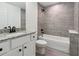 Bathroom with gray tile tub surround and granite countertop at 4482 Sw Clearwater Ct, Dunnellon, FL 34431