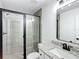 Bathroom with granite countertop, gray tile shower, and a black framed glass door at 4482 Sw Clearwater Ct, Dunnellon, FL 34431