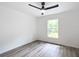 Bedroom with wood-look floors, ceiling fan, and large window at 4482 Sw Clearwater Ct, Dunnellon, FL 34431