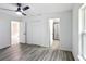 Bedroom with vinyl flooring, ceiling fan, and access to bathroom and closet at 4482 Sw Clearwater Ct, Dunnellon, FL 34431