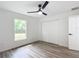 Bedroom featuring wood-look floors, ceiling fan and window at 4482 Sw Clearwater Ct, Dunnellon, FL 34431