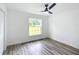 Spacious bedroom with wood-look vinyl flooring and a ceiling fan at 4482 Sw Clearwater Ct, Dunnellon, FL 34431