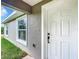 White front door and gray siding on house exterior at 4482 Sw Clearwater Ct, Dunnellon, FL 34431