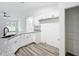 White kitchen with granite countertops and a pantry at 4482 Sw Clearwater Ct, Dunnellon, FL 34431