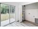 Bright laundry room features a sliding glass door, water heater, and vinyl flooring at 4482 Sw Clearwater Ct, Dunnellon, FL 34431