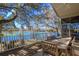 Deck with lake view and wooden dining set at 4925 Cr 309B, Lake Panasoffkee, FL 33538