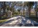 Long driveway entrance with stone pillars and wooden fence at 4925 Cr 309B, Lake Panasoffkee, FL 33538