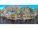 Waterfront home with expansive deck and lush landscaping at 4925 Cr 309B, Lake Panasoffkee, FL 33538