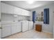 Bright laundry room with white cabinets and a window at 4925 Cr 309B, Lake Panasoffkee, FL 33538