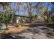 Tan metal storage shed situated on a tree-lined property at 4925 Cr 309B, Lake Panasoffkee, FL 33538