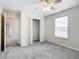 Bedroom with ceiling fan, grey carpet, and a double door closet at 5 Walnut Ct, Ocala, FL 34480