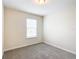 Simple bedroom with grey carpet and window at 5 Walnut Ct, Ocala, FL 34480