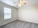 Spacious bedroom with ceiling fan and grey carpeting at 5 Walnut Ct, Ocala, FL 34480