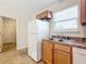 Bright kitchen with wood cabinets, white appliances, and a double sink at 5 Walnut Ct, Ocala, FL 34480