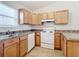 Modern kitchen featuring wood cabinets and tiled floor at 5 Walnut Ct, Ocala, FL 34480