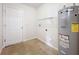 Laundry room with shelving, water heater, and tile floor at 5 Walnut Ct, Ocala, FL 34480