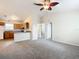 Open living room with kitchen and neutral carpeting at 5 Walnut Ct, Ocala, FL 34480