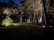 Landscaped backyard at night with lighting at 5224 Se 44Th Cir, Ocala, FL 34480